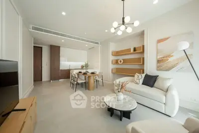 Modern open-plan living room with elegant decor and stylish kitchen area.