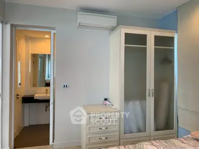 Modern bedroom with ensuite bathroom and sleek wardrobe design