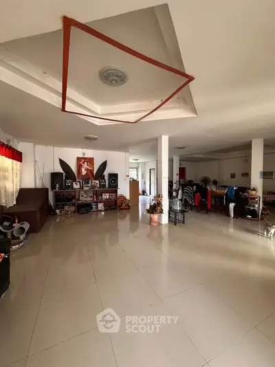 Spacious living room with modern decor and ample natural light, perfect for family gatherings.