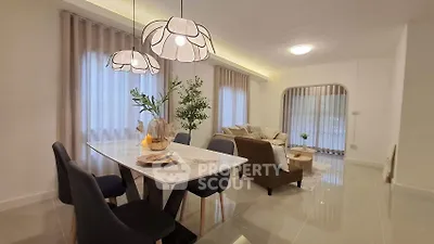 Elegant living room with modern dining area and stylish lighting, perfect for entertaining guests.