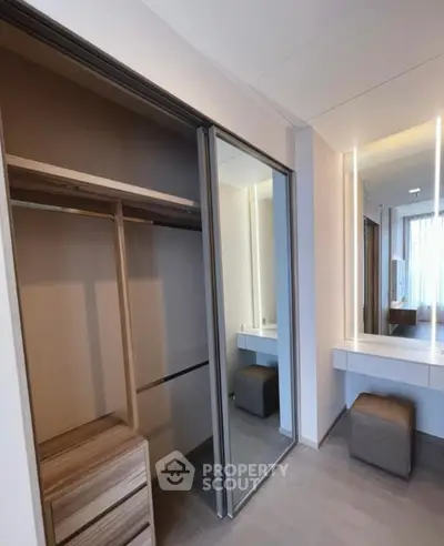 Modern bedroom with sleek closet and stylish vanity area