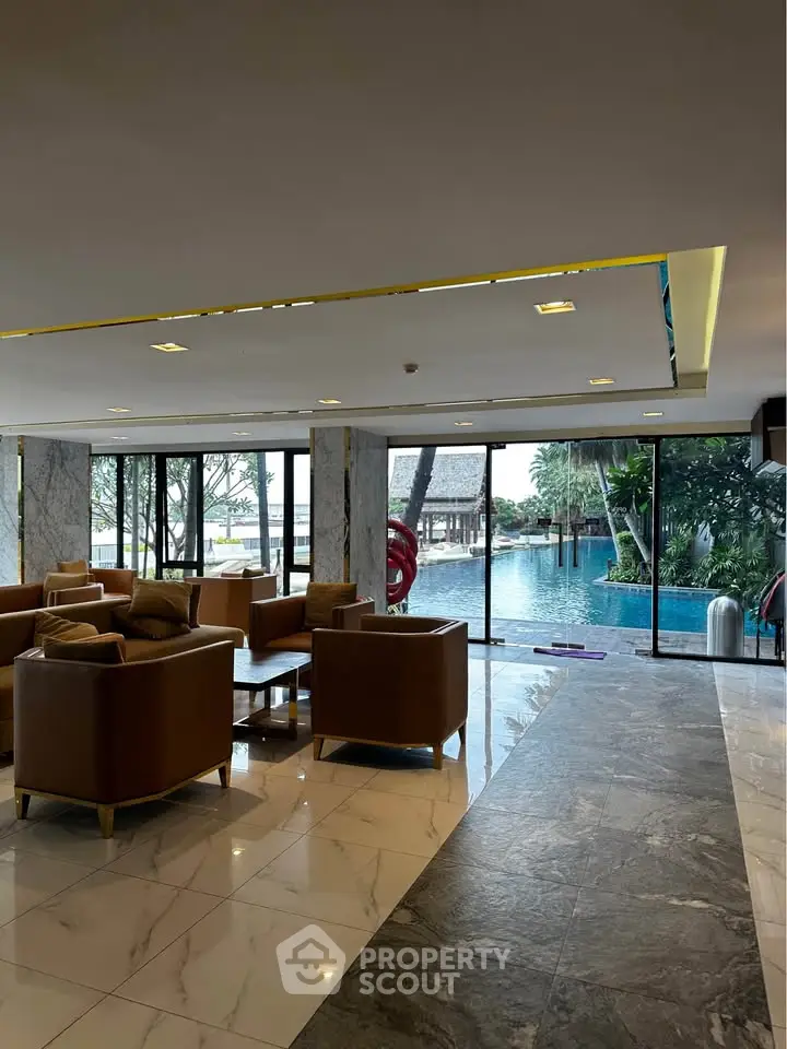 Luxurious hotel lobby with pool view and elegant seating area
