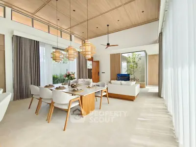 Luxurious open-plan living and dining area with elegant decor and natural light.