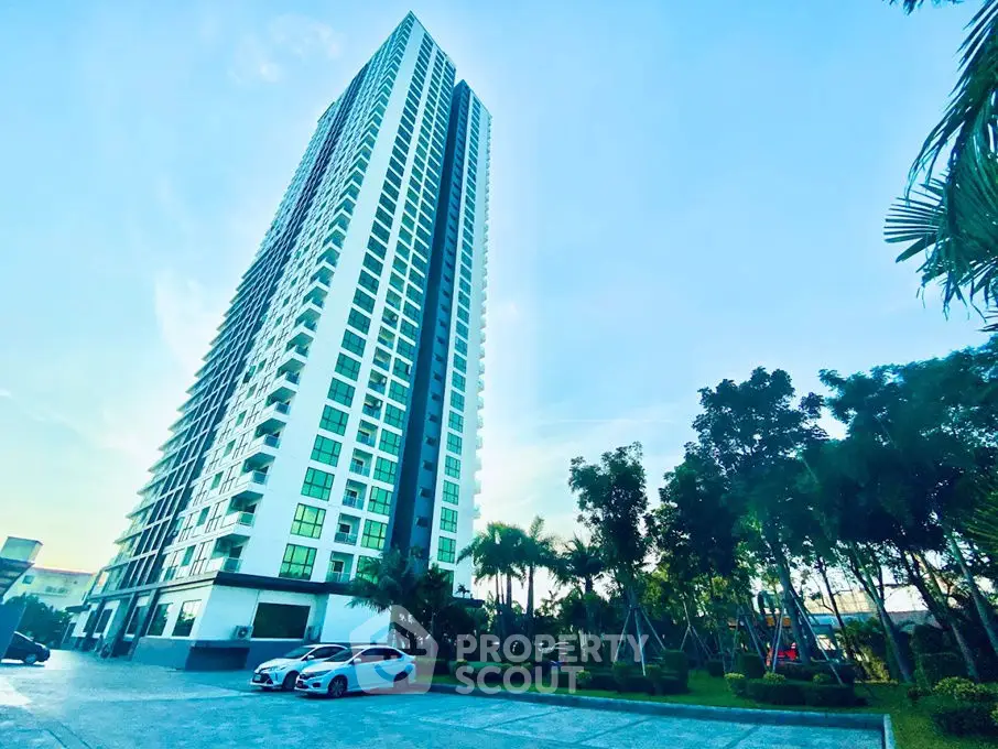 Stunning high-rise building with lush landscaping and ample parking space.
