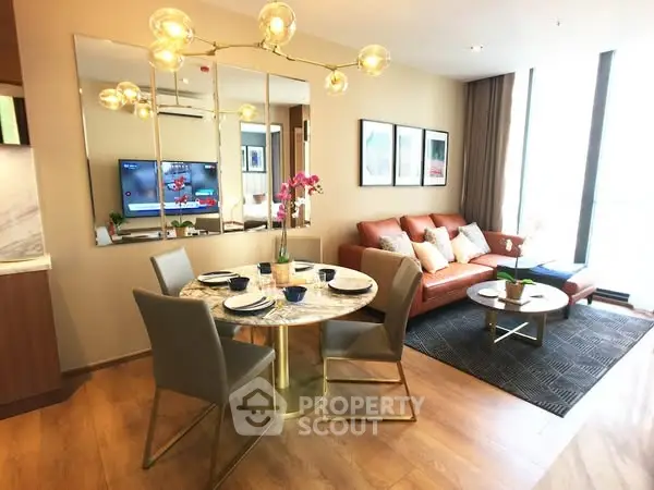 Stylish open-plan living room with modern dining area and chic decor