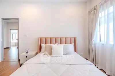 Bright and airy bedroom with modern decor and large windows