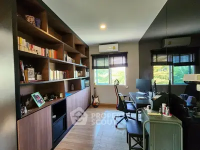 Modern home office with built-in shelves and dual monitors