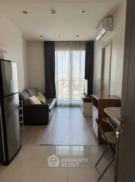 Modern living room with sleek furniture and large window view