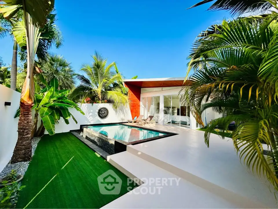 Luxurious modern villa with private pool and lush tropical garden, perfect for serene living.