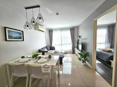 Modern living room with dining area, stylish lighting, and cozy bedroom view.