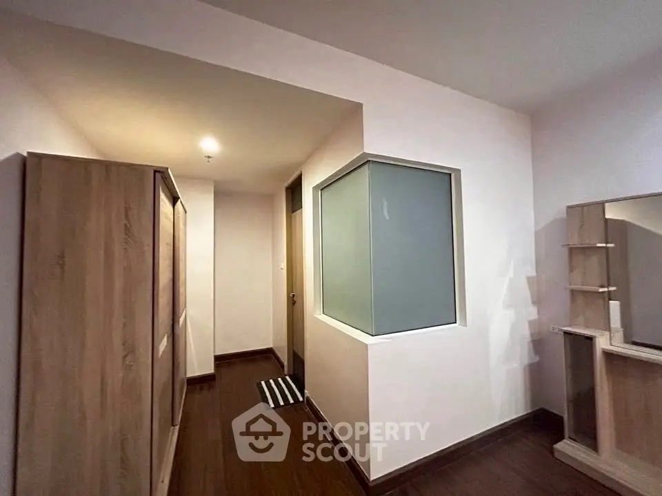 Modern hallway with wooden flooring and built-in wardrobe