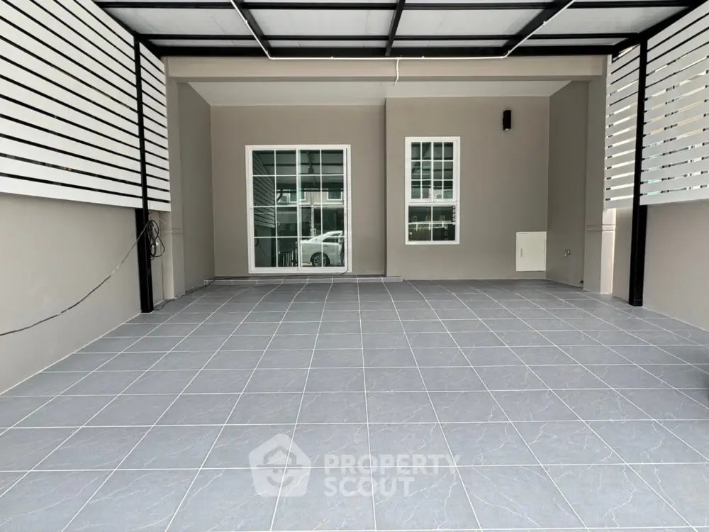 Modern covered parking area with tiled flooring and sleek design