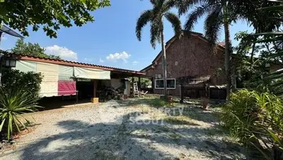 Charming rustic property with spacious outdoor area and lush greenery.