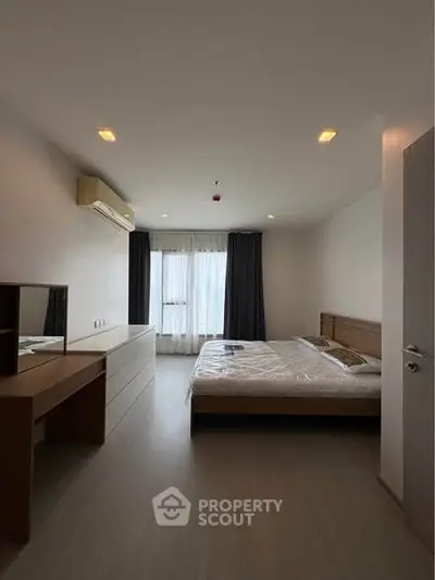 Spacious bedroom with modern furnishings and natural light