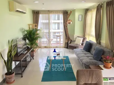 Spacious living room with modern decor and balcony access in a stylish apartment.