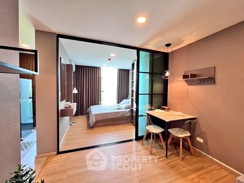 Modern open-plan living and bedroom area with stylish decor and natural light.
