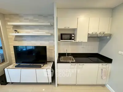 Modern kitchen with sleek cabinetry and integrated appliances in a stylish open layout.