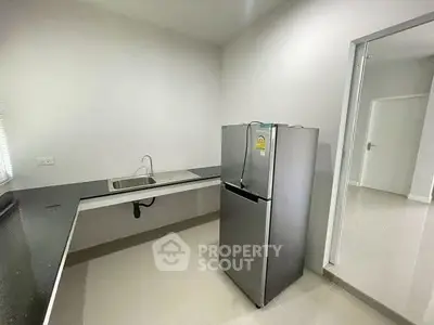 Modern kitchen with sleek fridge and minimalist design