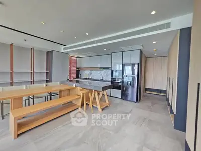 Modern kitchen with sleek design and open layout, featuring a stylish dining area and contemporary finishes.