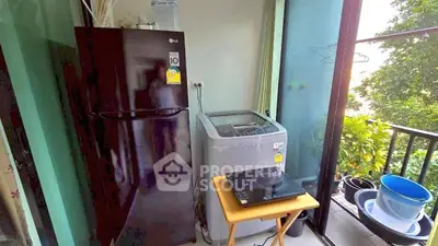 Compact balcony with fridge, washing machine, and lush greenery view