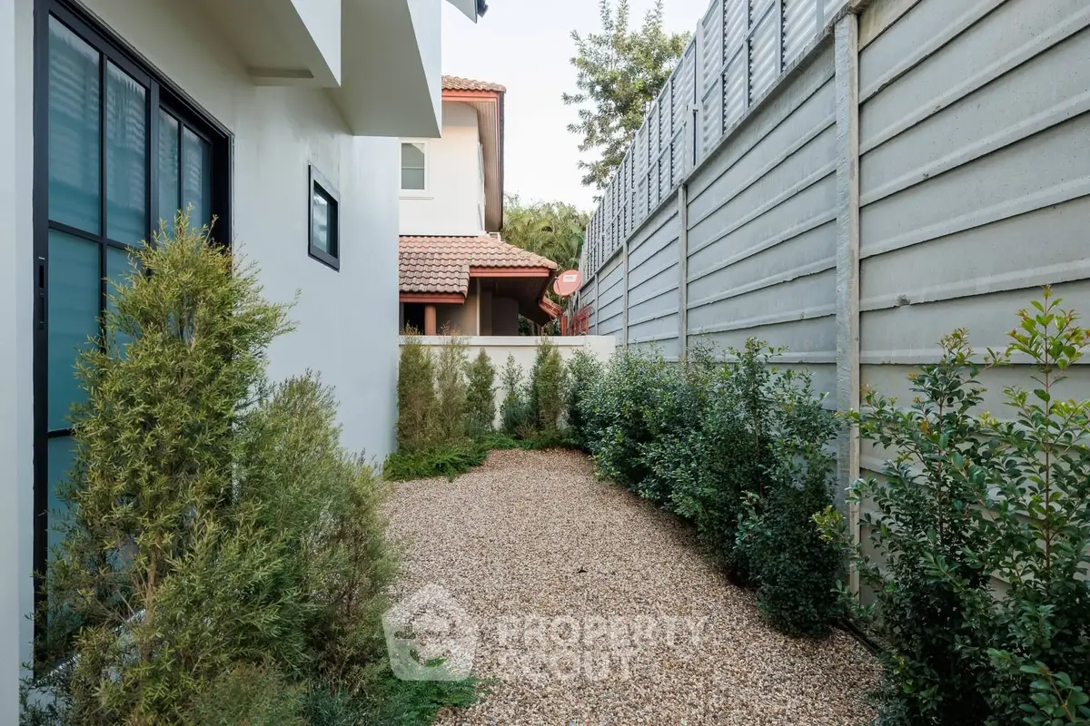 Charming garden area with privacy fence and lush greenery in modern residential property.