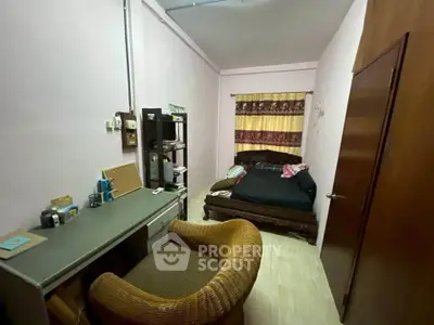 Cozy bedroom with desk and wicker chair, perfect for a comfortable living space.