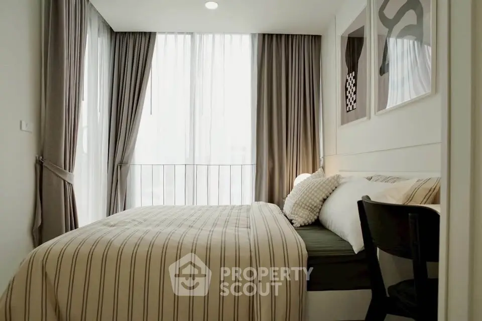 Cozy modern bedroom with large windows and stylish decor