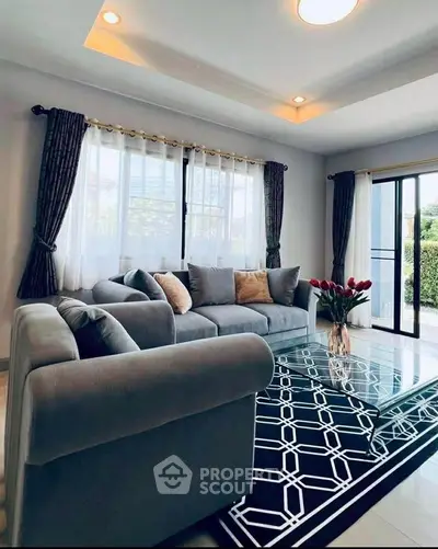 Stylish living room with modern decor, large windows, and elegant furniture, perfect for relaxation and entertaining.