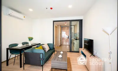 Bright and modern living room seamlessly connected to a cozy dining area, featuring sleek furniture and a welcoming ambiance.