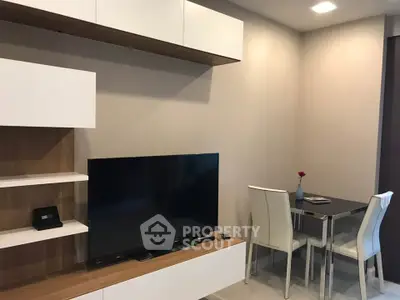 Modern living room with sleek TV unit and cozy dining area