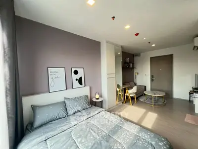 Modern bedroom with stylish decor and cozy seating area in a chic apartment.