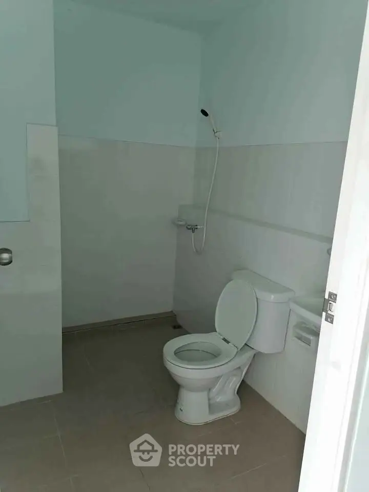 Minimalist bathroom with shower and toilet in modern apartment