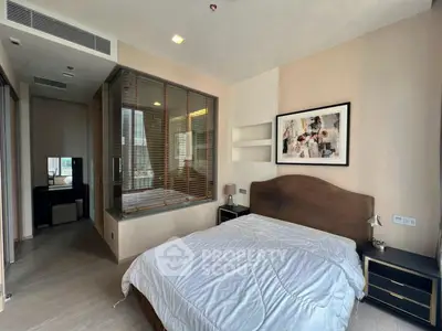 Modern bedroom with stylish decor and large window for natural light