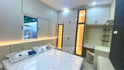 Modern bedroom with built-in wardrobes and ambient lighting