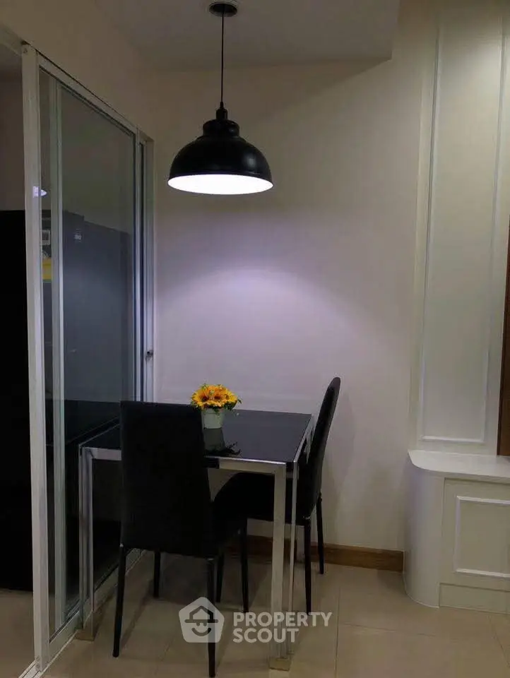 Cozy dining nook with modern lighting and sleek black chairs