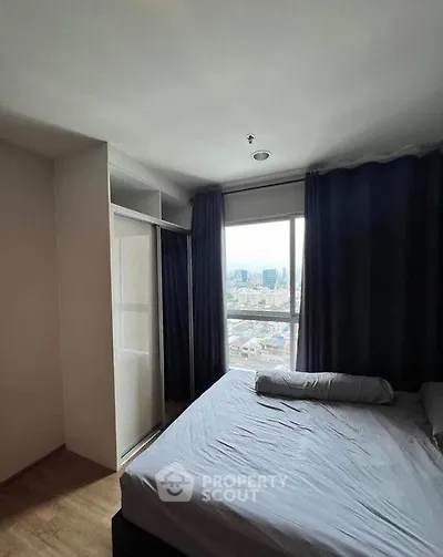 Modern bedroom with city view and large window, featuring a cozy bed and built-in closet.