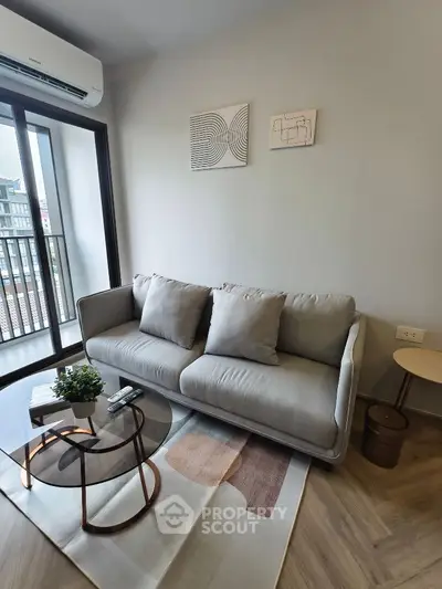 Modern living room with cozy sofa and stylish decor in a bright apartment.