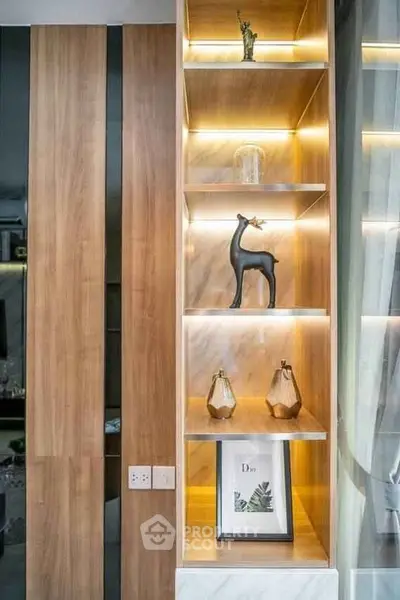 Stylish modern interior with illuminated wooden shelves and elegant decor pieces.