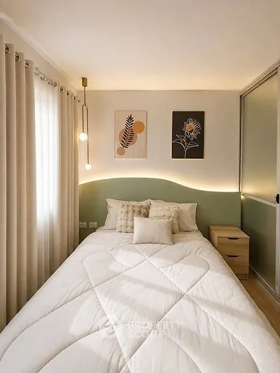 Cozy bedroom with modern decor and soft lighting, featuring a comfortable bed and stylish wall art.