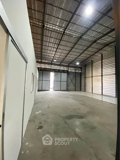 Spacious industrial warehouse with high ceilings and ample storage space.