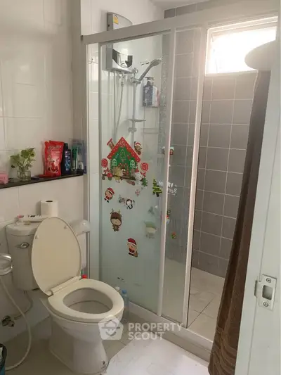 Cozy bathroom with shower and festive decorations, perfect for a cheerful home ambiance.