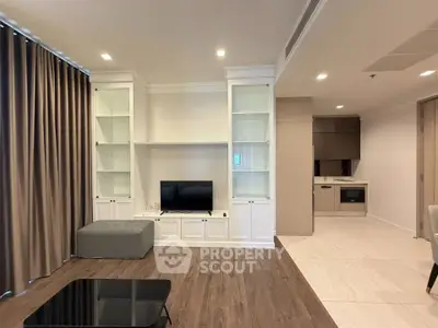 Spacious modern living room with elegant built-in shelving and cozy seating area.