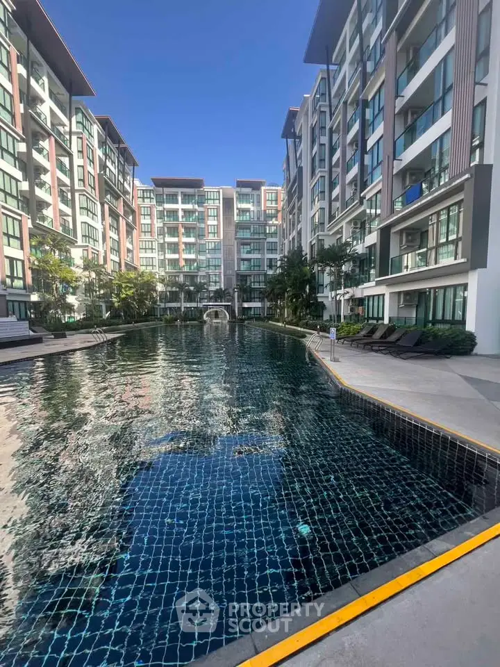 Luxurious condominium with stunning pool and modern architecture, perfect for urban living.