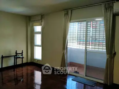 Spacious living room with sliding glass doors leading to a cozy balcony.