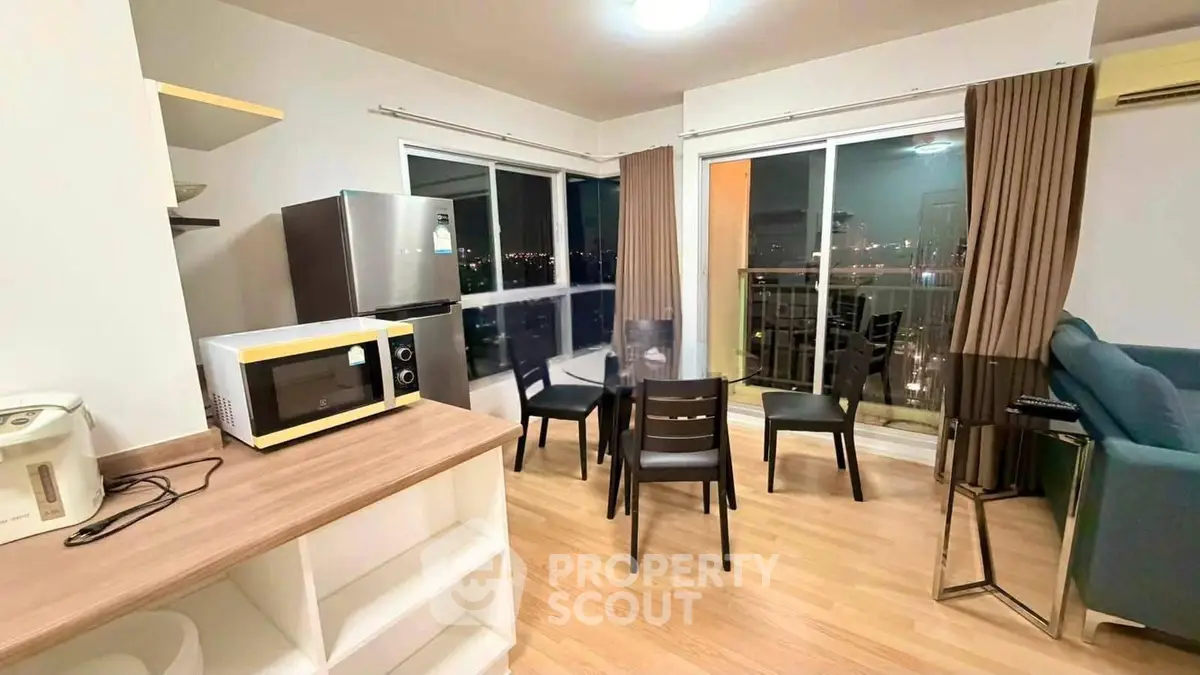 Modern living room with dining area and balcony view in a stylish apartment.