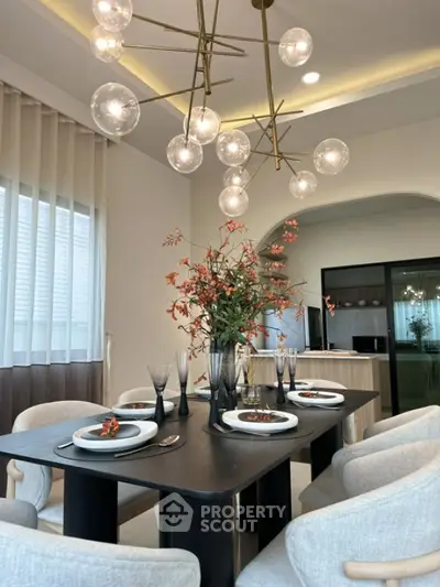 Elegant dining room with modern chandelier and stylish table setting in a contemporary home.