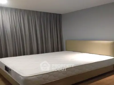 Spacious bedroom with modern design and large bed, perfect for relaxation.