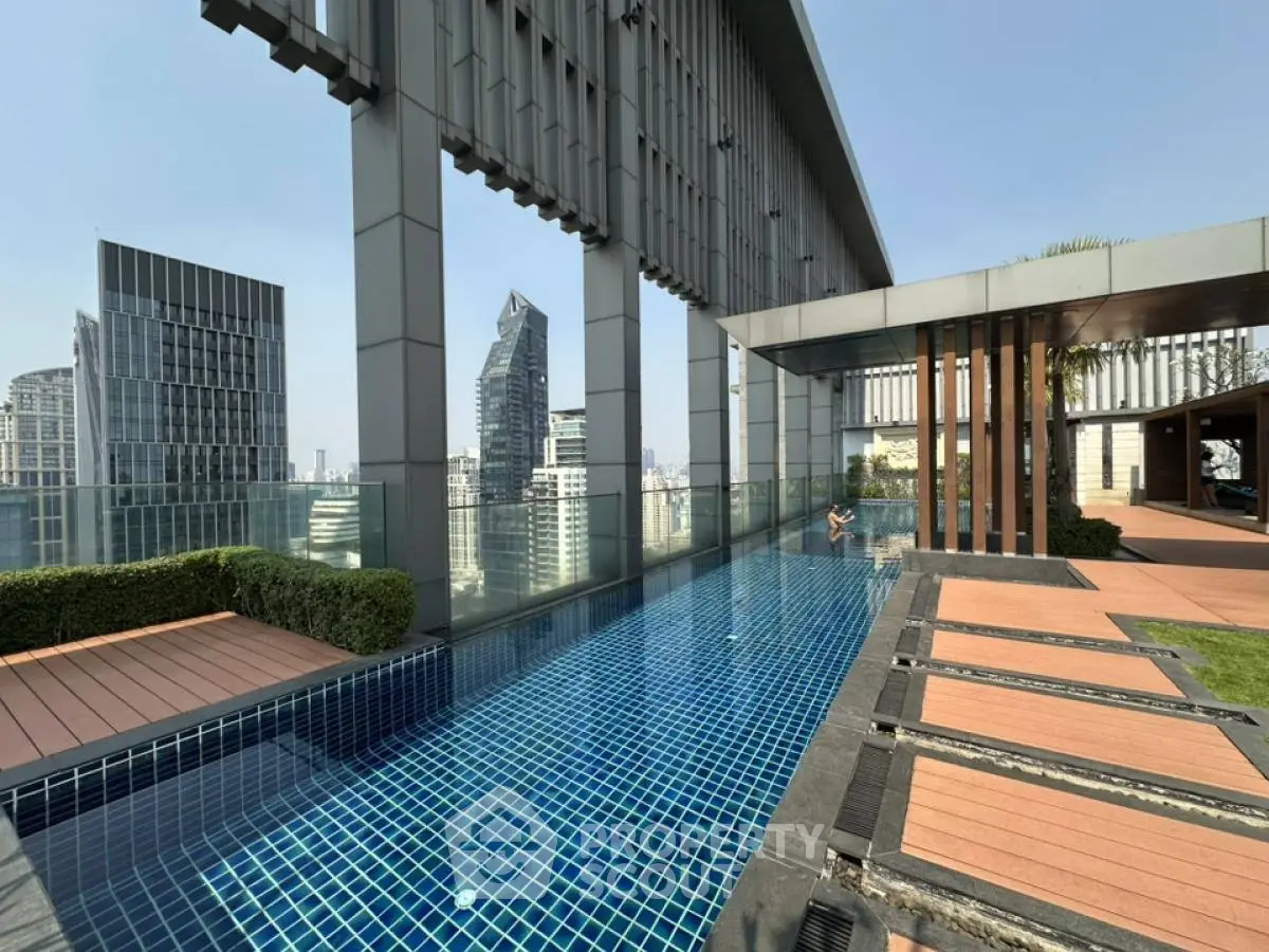 Luxurious rooftop pool with stunning cityscape views in modern high-rise building.