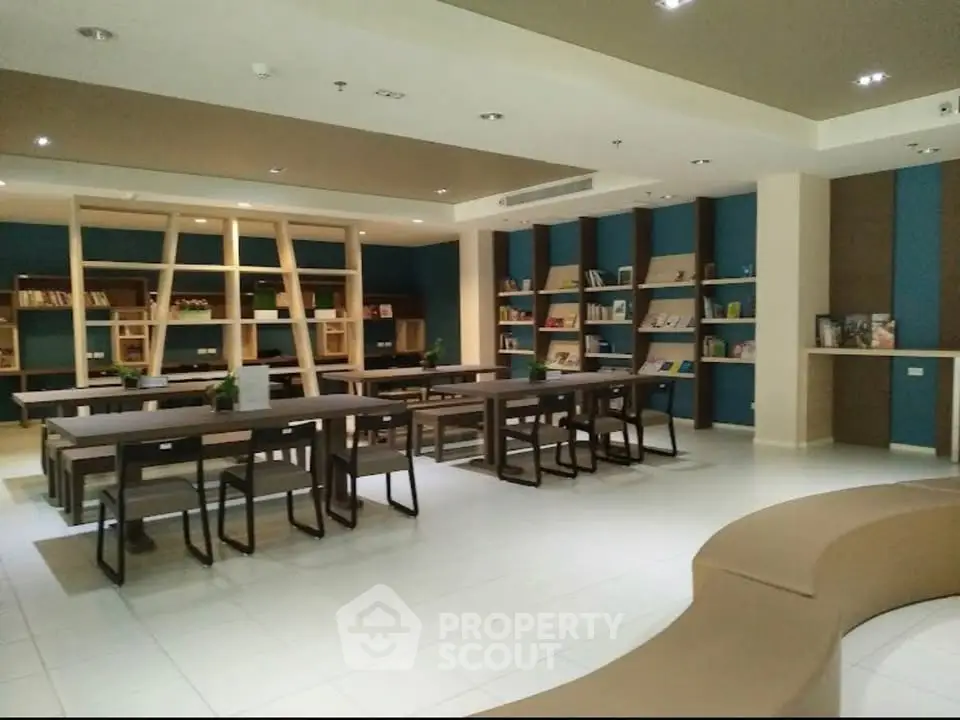 Modern library with sleek wooden shelves and ample seating in a contemporary building.