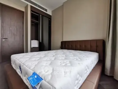 Modern bedroom with plush mattress and sleek wardrobe in a stylish apartment.